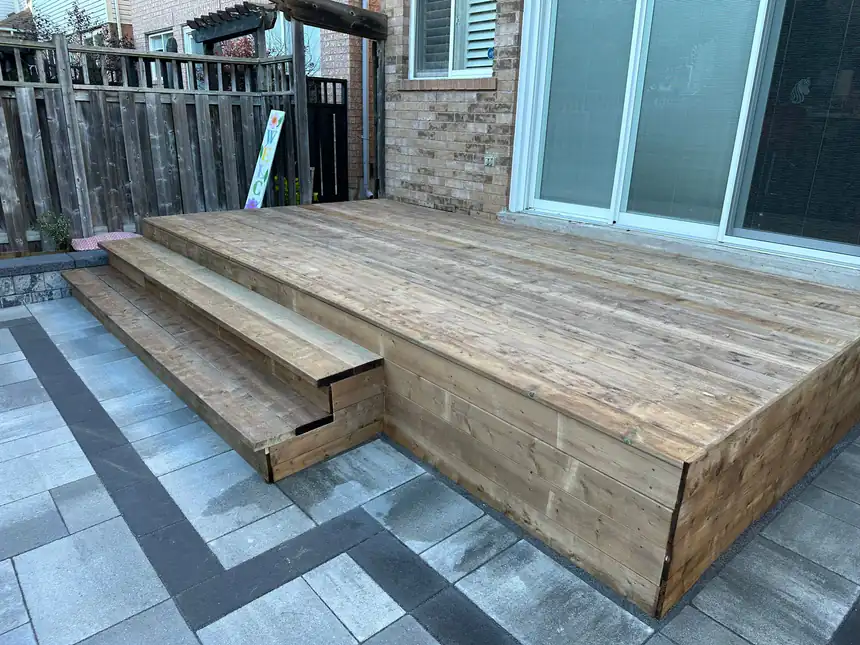 Cedar deck with interlock surround by World Gate Landscaping